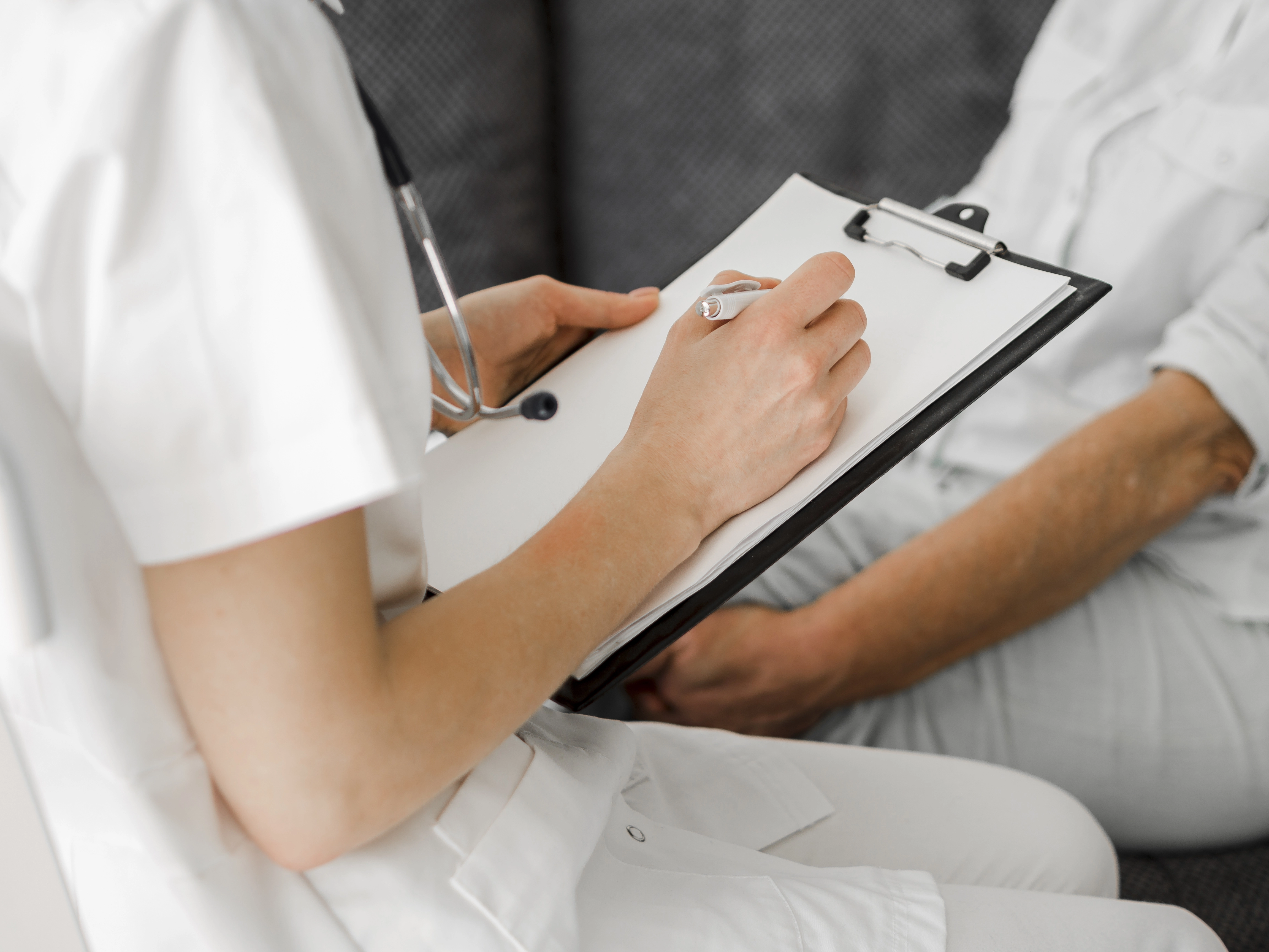close-up-doctor-taking-notes